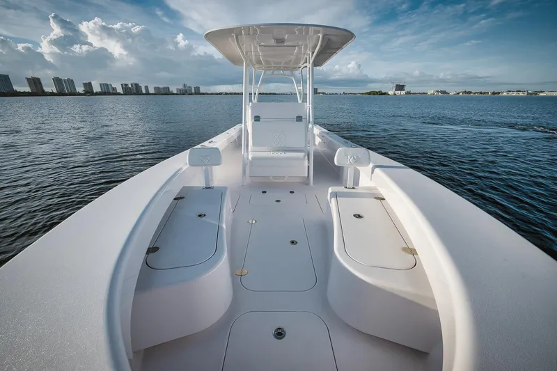 Slide: The Image of 2024 Birdsall 30 boat on calm water with city skyline in background. - 14