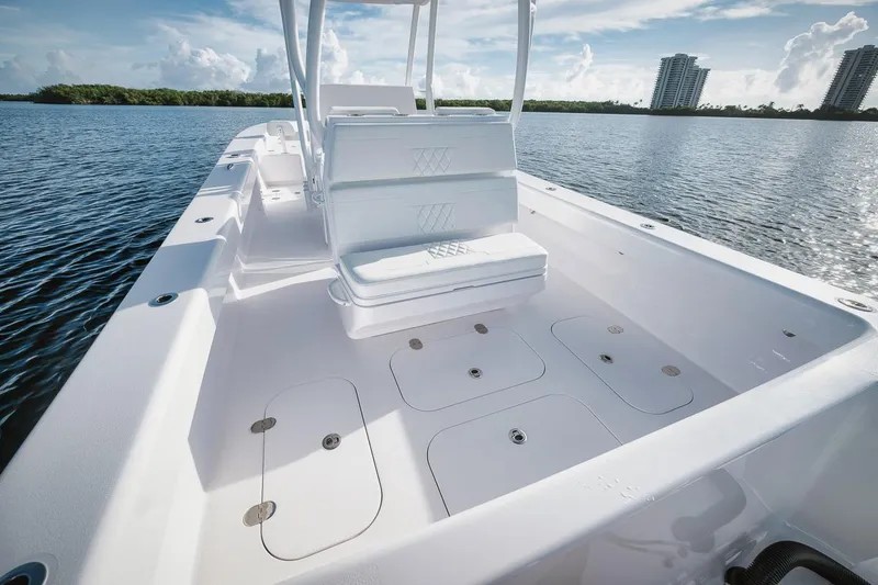 Slide: The Image of 2024 Birdsall 30 boat interior with seating and storage compartments on a calm water body. - 27