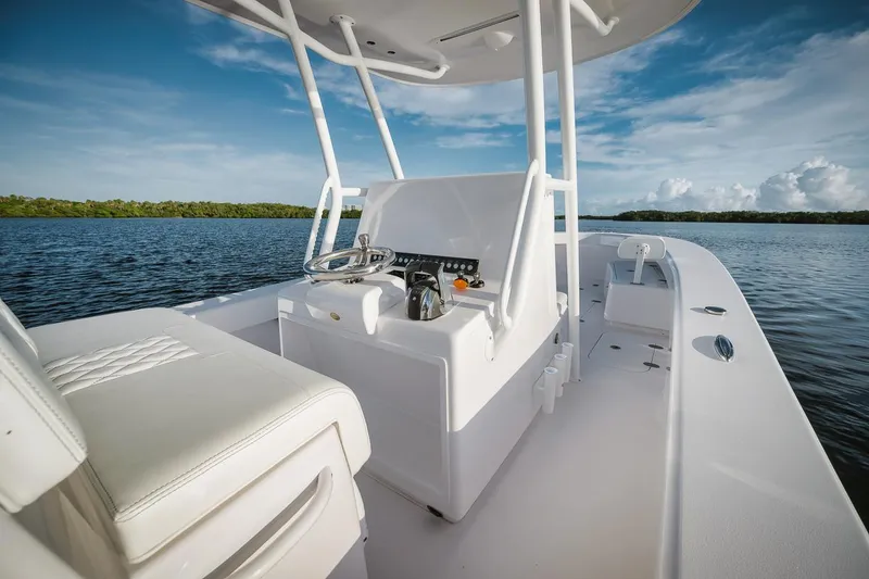Slide: The Image of 2024 Birdsall 30 boat interior with steering console on calm water. - 3