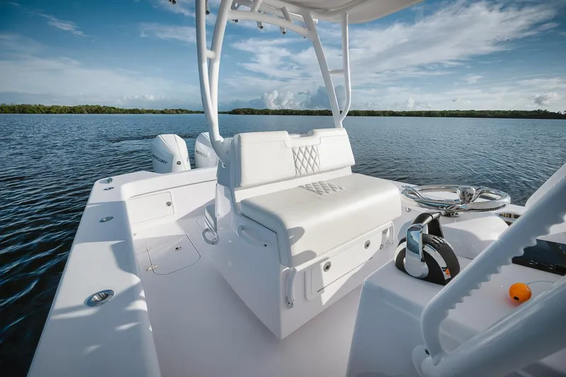 Slide: The Image of 2024 Birdsall 30 boat interior with white seating on a calm lake. - 4
