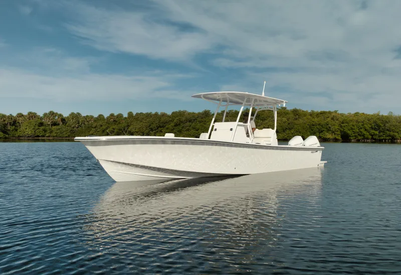 Slide: The Image of 2024 Birdsall 30 boat on calm water with forested shoreline in the background. - 40