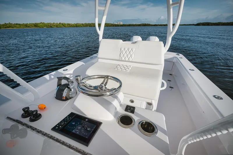 Slide: The Image of 2024 Birdsall 30 boat interior with steering wheel and control panel on calm water. - 5