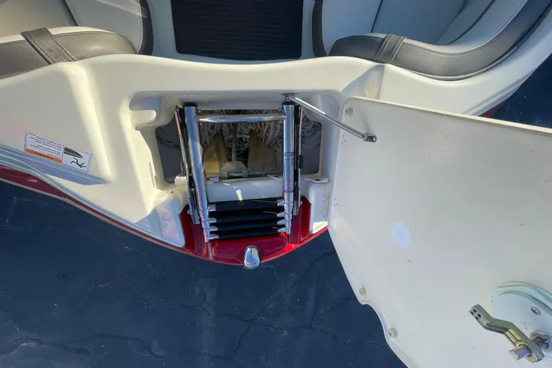 Slide: The Image of 2014 Yamaha Boats 242 Limited S swim platform with ladder storage compartment open. - 11