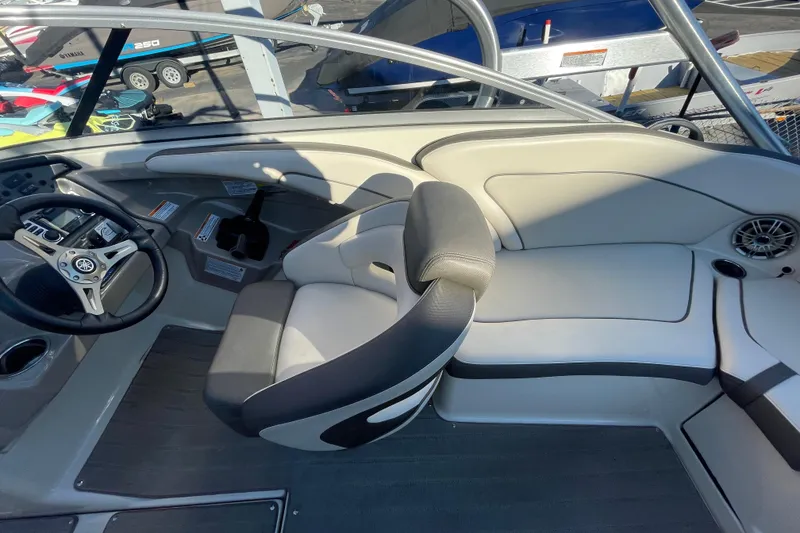 Slide: The Image of 2014 Yamaha Boats 242 Limited S interior with steering wheel and seating area. - 15