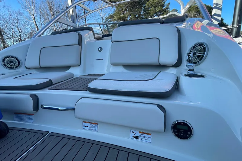 Slide: The Image of 2014 Yamaha Boats 242 Limited S interior with cushioned seating and audio system. - 16