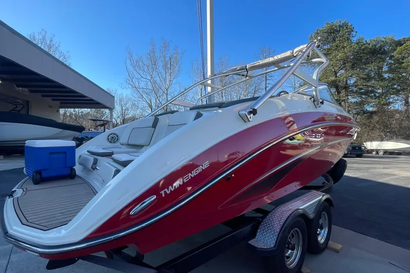 Slide: The Image of 2014 Yamaha Boats 242 Limited S, red and white, on trailer, outdoor setting. - 18