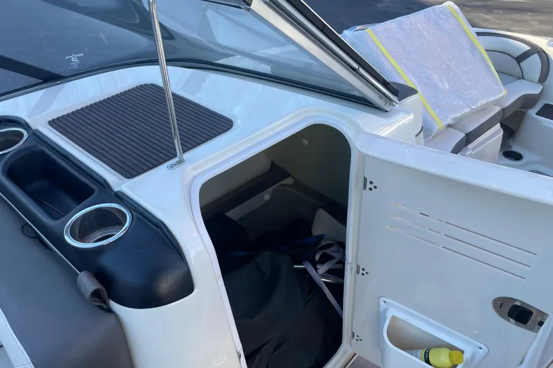 Slide: The Image of 2014 Yamaha Boats 242 Limited S interior storage compartment with cup holders and seating. - 8