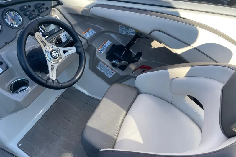 Slide: The Image of 2014 Yamaha Boats 242 Limited S cockpit with steering wheel and controls. - 9