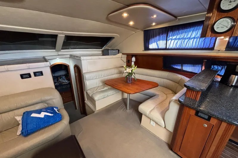 Slide: The Image of 2005 Cruisers Yachts 455 Express Motoryacht helm with navigation equipment and wooden steering wheel. - 12