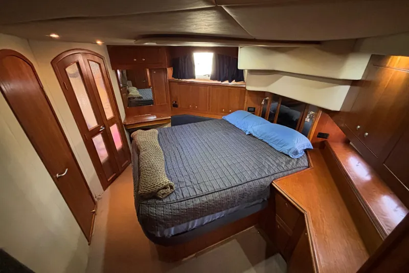 Slide: The Image of Luxurious bedroom interior of 2005 Cruisers Yachts 455 Express Motoryacht with geometric bedspread. - 19