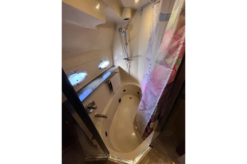 Slide: The Image of Luxurious Master bathroom in 2005 Cruisers Yachts 455 Express Motoryacht with Linen Closet, Vanity, medicine cabinets and access to tub/shower. - 26