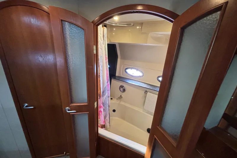 Slide: The Image of Luxurious bathroom in 2005 Cruisers Yachts 455 Express Motoryacht with Jacuzzi Tub/Shower and twin portholes. - 28