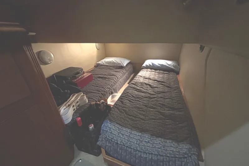 Slide: The Image of 2005 Cruisers Yachts 455 Express Motoryacht third guest cabin with twin beds and storage. - 15