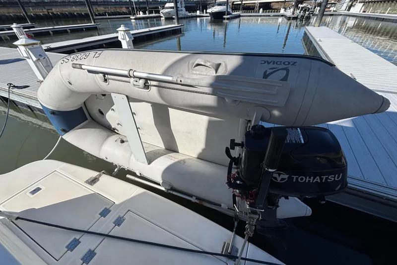 Slide: The Image of 2005 Cruisers Yachts 455 Express Motoryacht with inflatable dinghy and Tohatsu outboard motor on the Weaver Davit System - 2