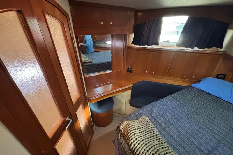 Slide: The Image of 2005 Cruisers Yachts 455 Express Motoryacht Master Stateroom Vanity and French Doors leading to the Jacuzzi Tub - 20