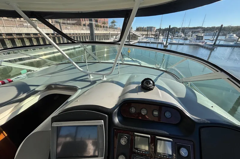 Slide: The Image of 2005 Cruisers Yachts 455 Express Motoryacht helm with marina view. - 7