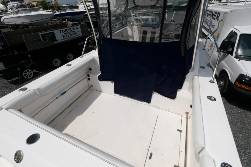 Slide: The Image of 2001 Boston Whaler 23 Conquest boat deck with seating and covered cockpit. - 4