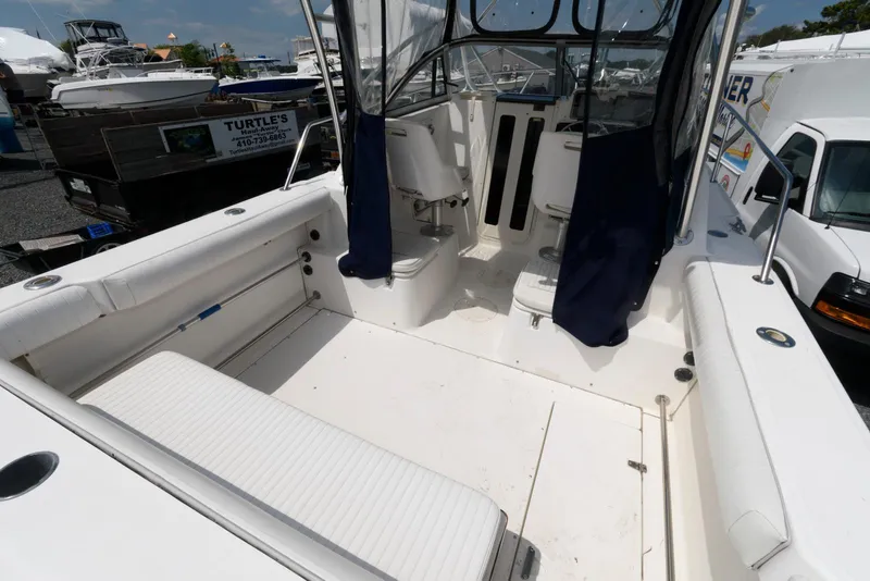 Slide: The Image of 2001 Boston Whaler 23 Conquest boat interior with seating and cockpit view. - 6