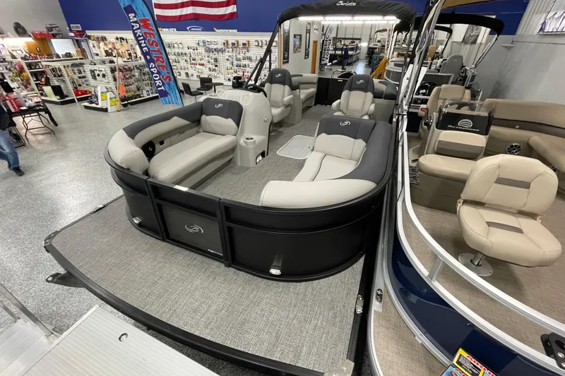 Slide: The Image of 2026 Barletta Sanza S22QC Tri pontoon boat displayed in a showroom. - 7