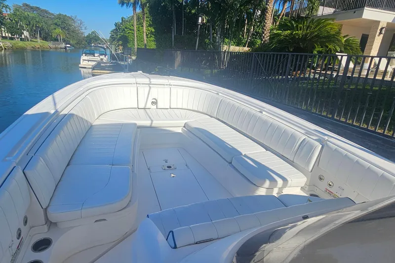 Slide: The Image of 2015 Intrepid 327 Center Console boat with spacious white seating on a sunny day. - 11