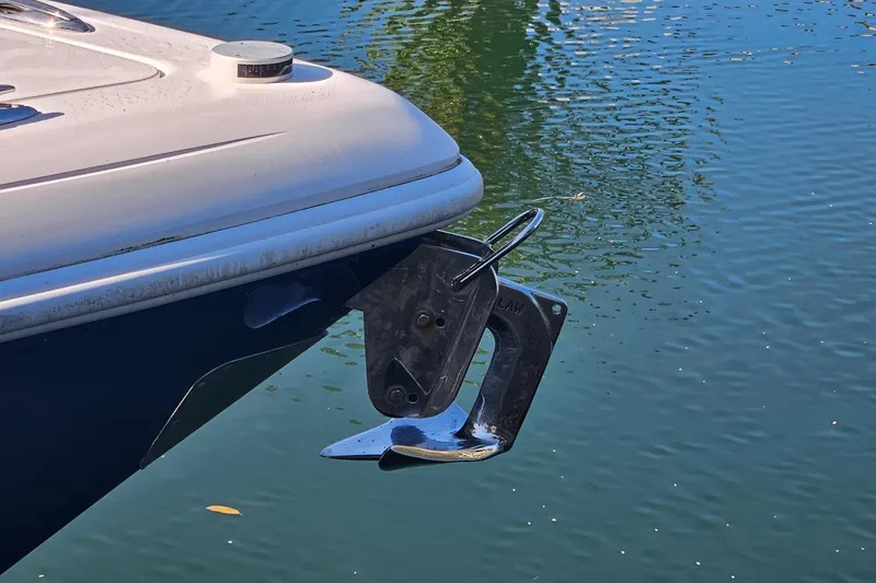 Slide: The Image of 2015 Intrepid 327 Center Console boat anchor detail on calm water. - 16