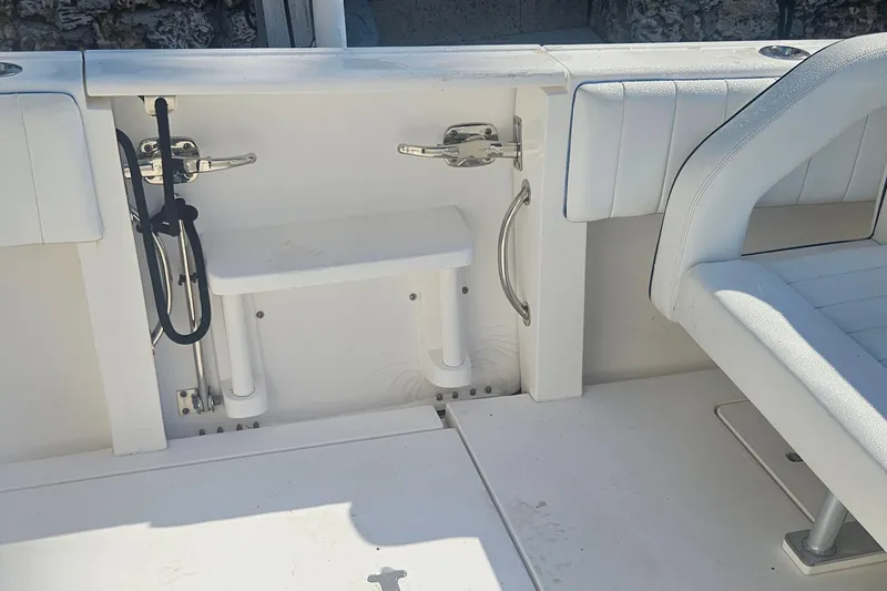 Slide: The Image of 2015 Intrepid 327 Center Console interior with white seating and storage area. - 18