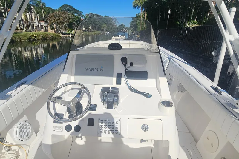 Slide: The Image of 2015 Intrepid 327 Center Console boat cockpit with Garmin navigation system. - 19