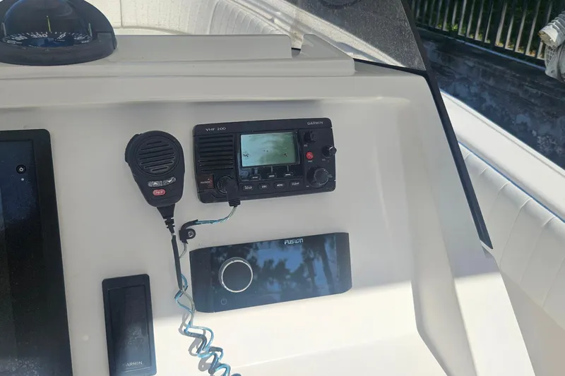 Slide: The Image of 2015 Intrepid 327 Center Console dashboard with Garmin VHF 200 radio and Fusion audio system. - 21