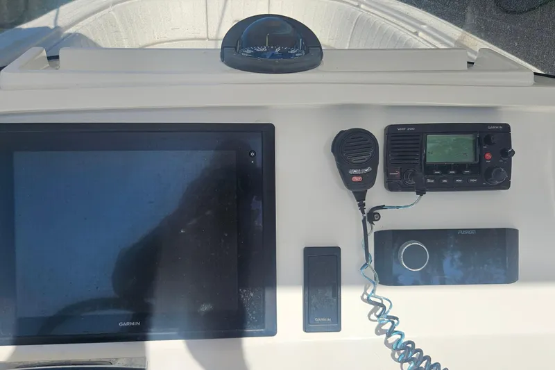 Slide: The Image of 2015 Intrepid 327 Center Console dashboard with Garmin electronics and VHF radio. - 22