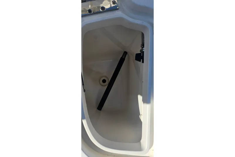 Slide: The Image of Storage compartment of 2015 Intrepid 327 Center Console boat, featuring a clean interior. - 28