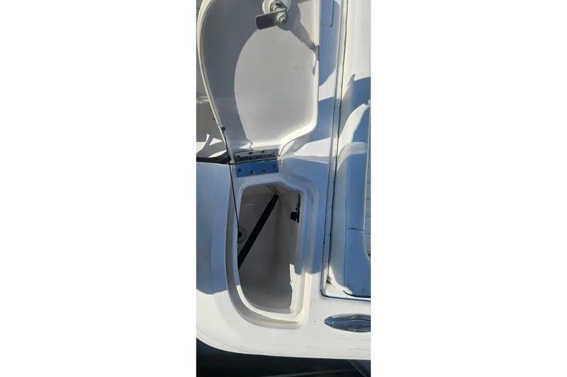 Slide: The Image of Open storage compartment on 2015 Intrepid 327 Center Console boat. - 29