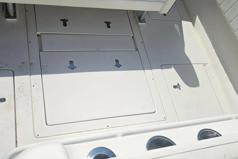 Slide: The Image of 2015 Intrepid 327 Center Console deck with storage compartments and cup holders. - 7