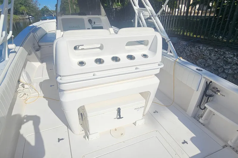 Slide: The Image of 2015 Intrepid 327 Center Console boat interior with seating and storage compartments. - 8