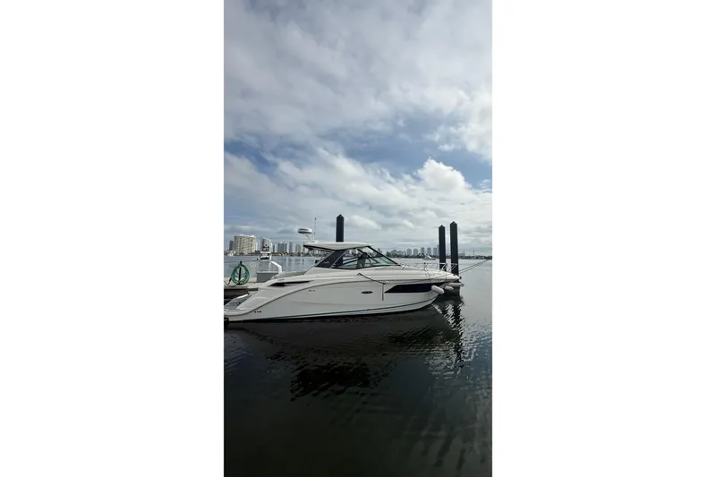 The Image of 2021 Sea Ray Sundancer 320 yacht docked at marina under cloudy sky. - 0
