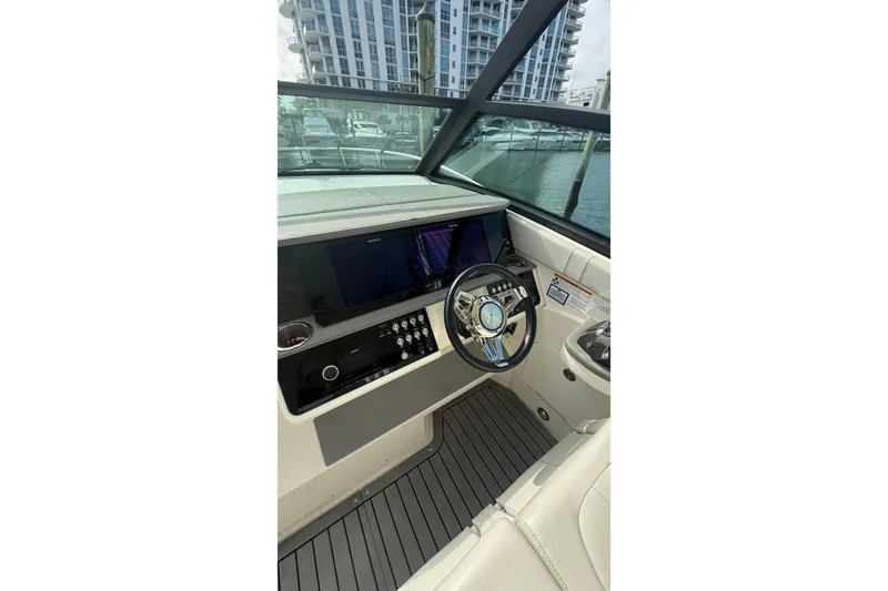 Slide: The Image of 2021 Sea Ray Sundancer 320 helm with modern controls and sleek design. - 15