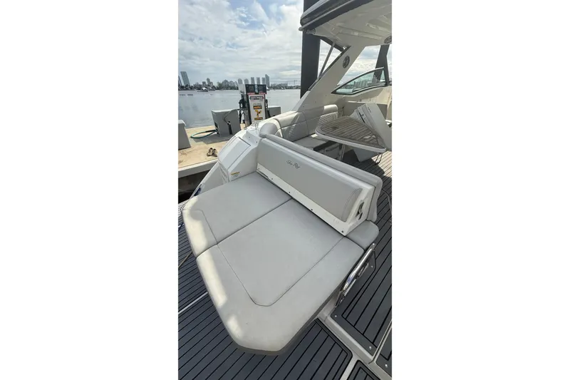 Slide: The Image of 2021 Sea Ray Sundancer 320 boat interior with luxurious seating and waterfront view. - 20