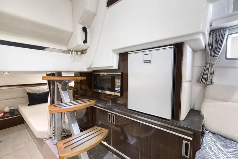 Slide: The Image of Manufacturer Provided Image: Interior of 2021 Sea Ray Sundancer 320 with kitchenette and seating area. - 24
