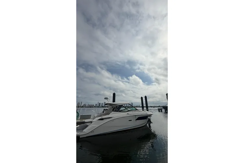 Slide: The Image of 2021 Sea Ray Sundancer 320 yacht docked under cloudy sky. - 3