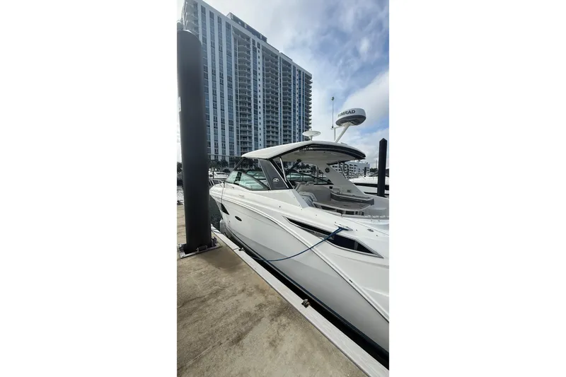 Slide: The Image of 2021 Sea Ray Sundancer 320 docked near modern high-rise building. - 7
