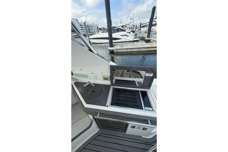 Slide: The Image of 2021 Sea Ray Sundancer 320 yacht with outdoor grill and sink at marina. - 9