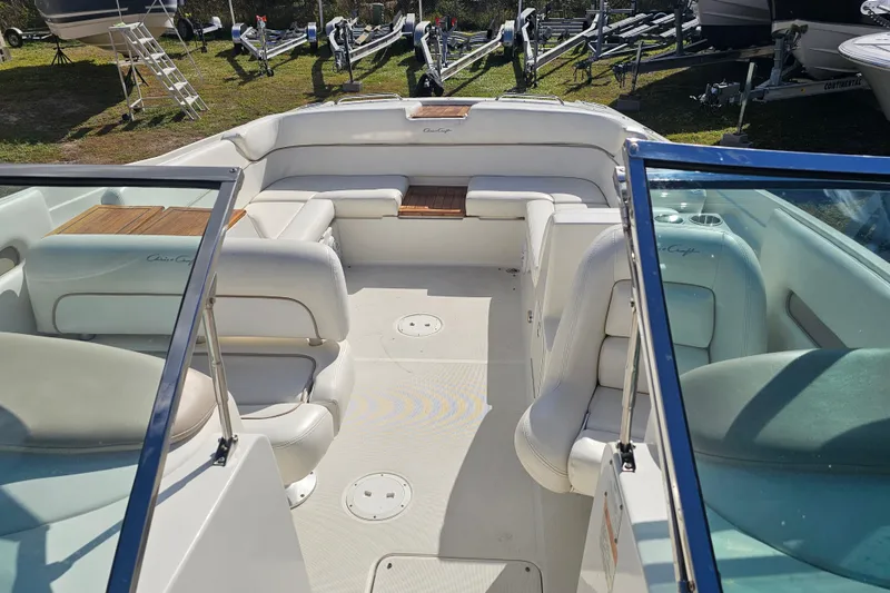 Slide: The Image of 2008 Chris-Craft Launch 28 boat interior with white seating and wooden accents. - 12