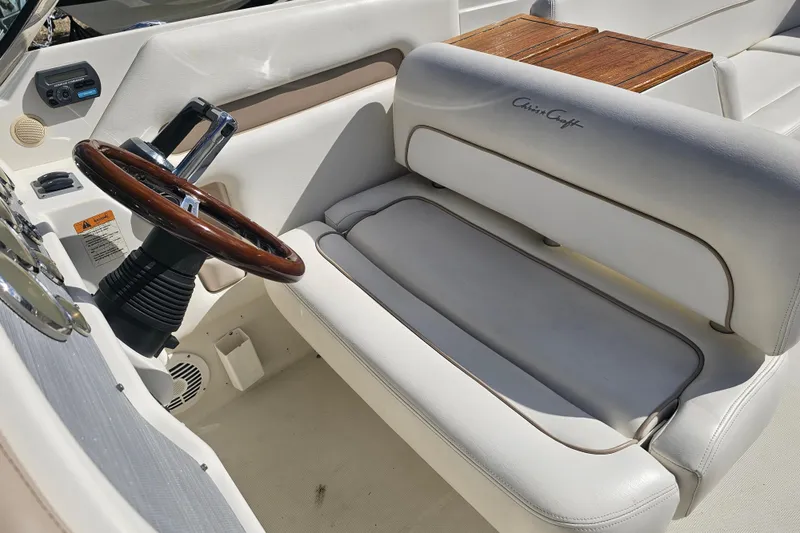 Slide: The Image of Luxurious interior of 2008 Chris-Craft Launch 28 with wooden steering wheel and leather seating. - 13