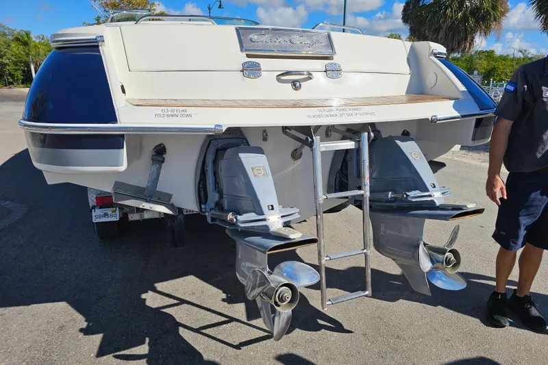 Slide: The Image of 2008 Chris-Craft Launch 28 boat rear view with dual propellers and ladder. - 2