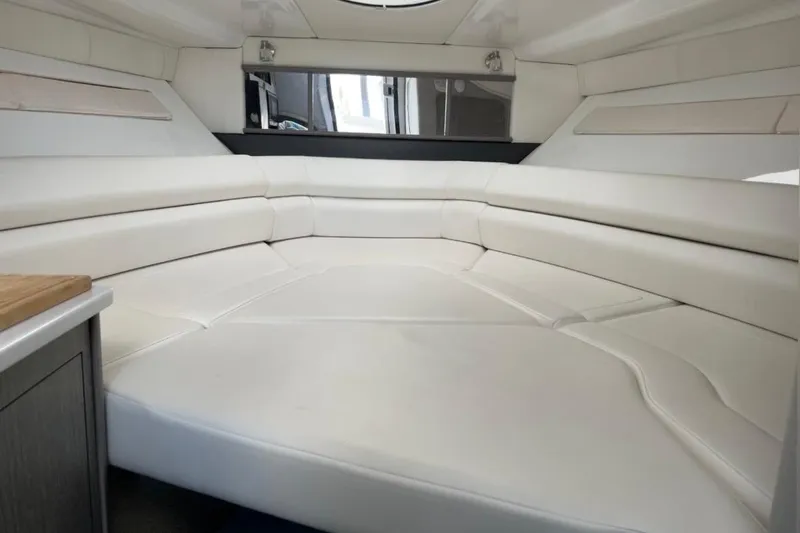 Slide: The Image of Interior of 2021 Monterey 295 Sport Yacht with white leather seating and modern design. - 13
