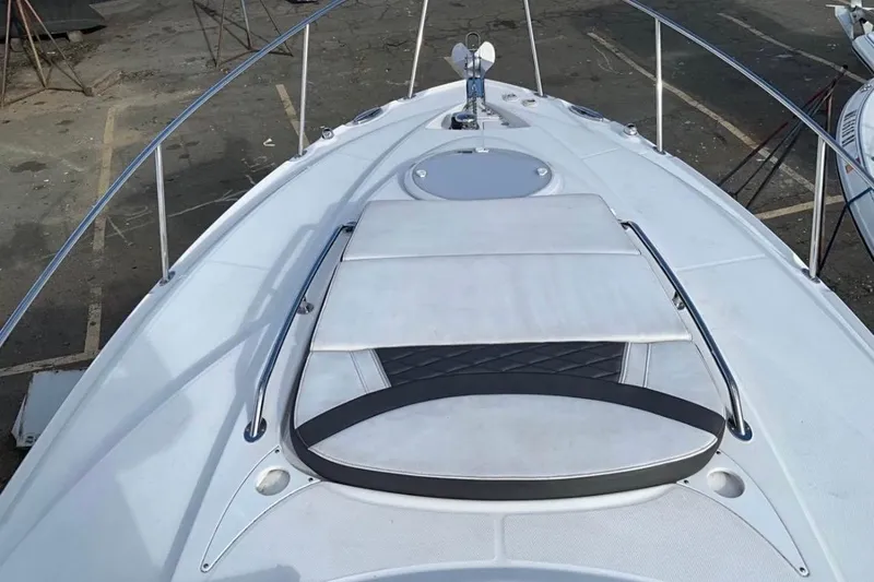 Slide: The Image of 2021 Monterey 295 Sport Yacht bow with sunpad and stainless steel rails. - 16