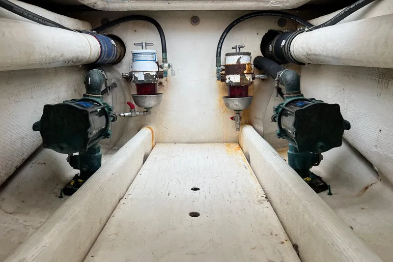 Slide: The Image of Engine compartment of a 1996 Henriques 28 Express boat, showing fuel filters and pumps. - 11