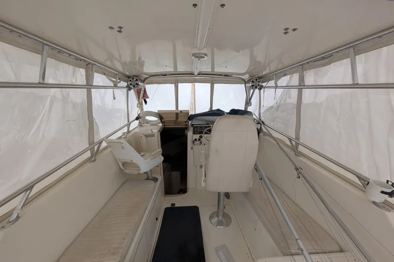 Slide: The Image of Interior of a 1996 Henriques 28 Express boat with seating and helm. - 14
