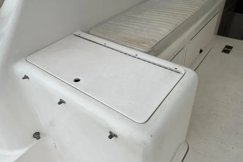 Slide: The Image of 1996 Henriques 28 Express boat interior with white seating and storage compartments. - 16