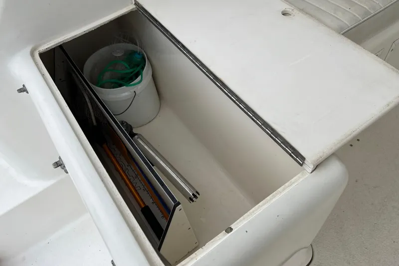 Slide: The Image of Storage compartment on a 1996 Henriques 28 Express boat with fishing gear and bucket. - 17