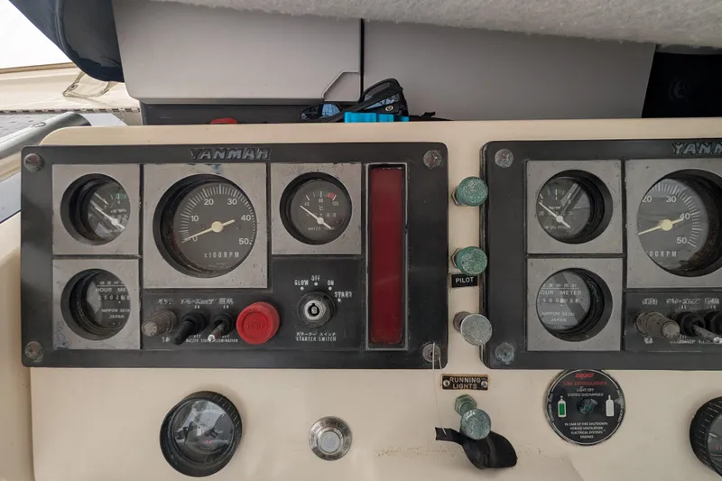 Slide: The Image of 1996 Henriques 28 Express dashboard with Yanmar engine gauges and controls. - 19